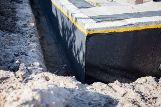Professional Exterior Waterproofing technician working in Utica, NY